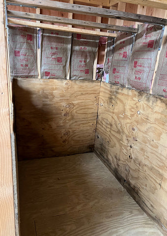 progress photo of DIY infrared sauna construction showing plywood installation