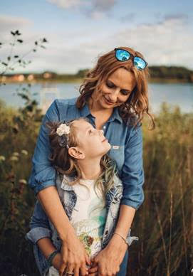 mother hugging her tween daughter from behind