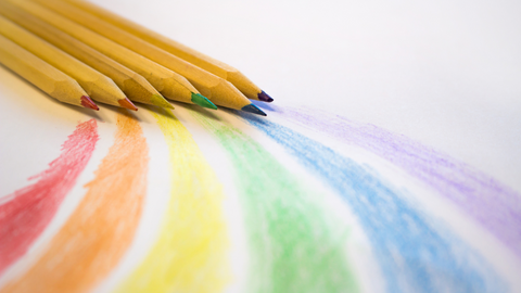 six pencil crayons drawing rainbow