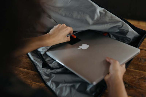 Pulling apple laptop out of the laptop sleeve