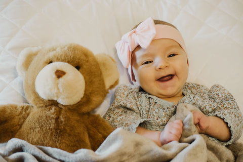 Baby Laughing with Teddy Bear