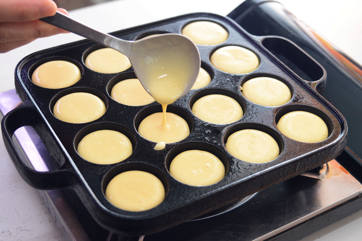 Pour the dough into each hole of the takoyaki cooker.