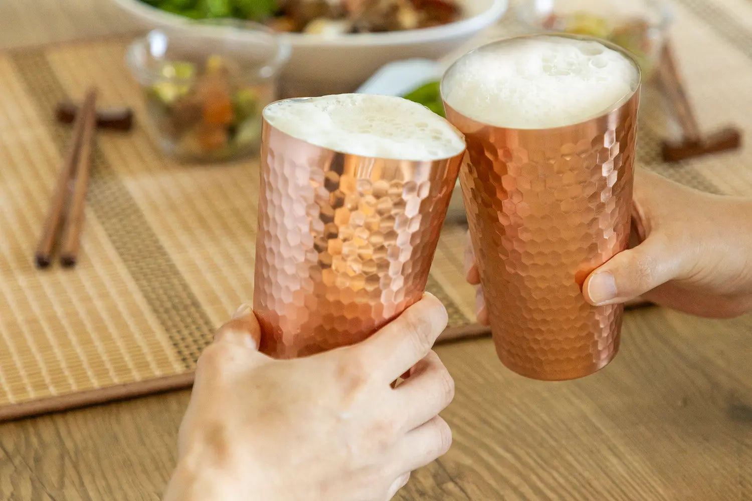 Copper tumblers on table