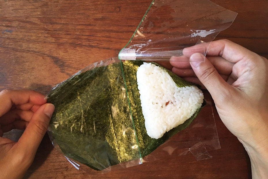 Place the rice ball onto seaweed