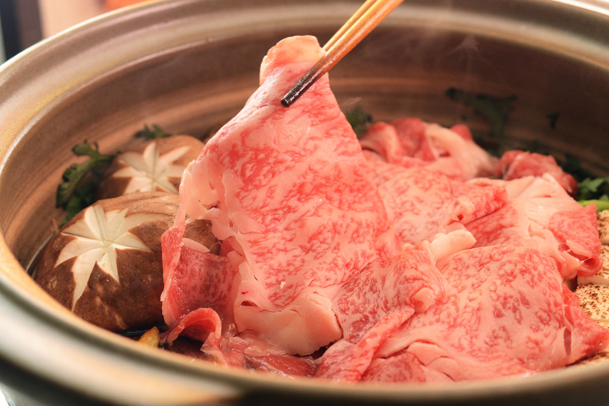 Sukiyaki is usually made with ingredients such as beef, green onions, grilled tofu, shirataki mushrooms, and shiitake mushrooms.