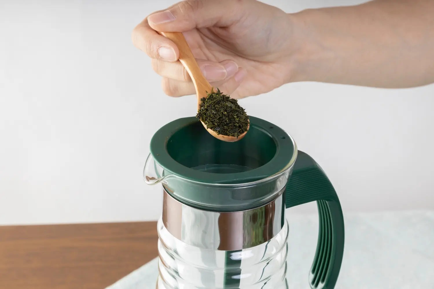 Adding green tea leaves to the basket filter of the Hario Iced Tea Brewer