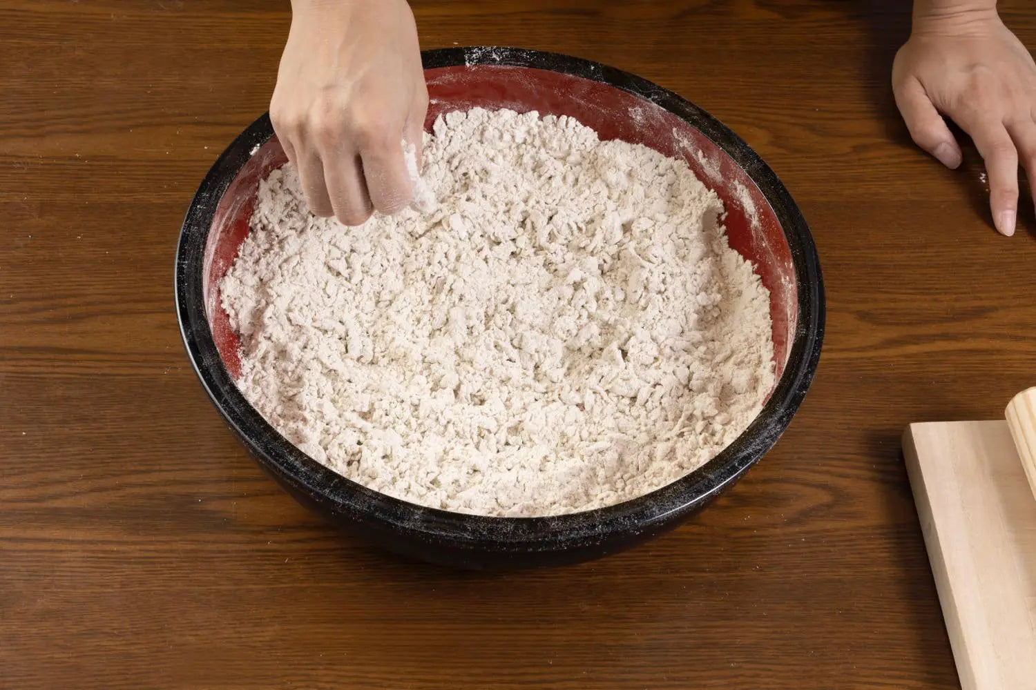 Slowly mixing water into flour mixture