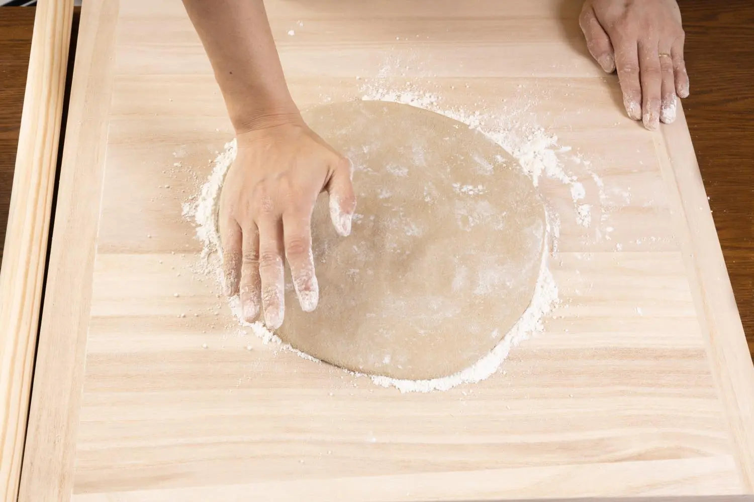 Flattening the dough by hand