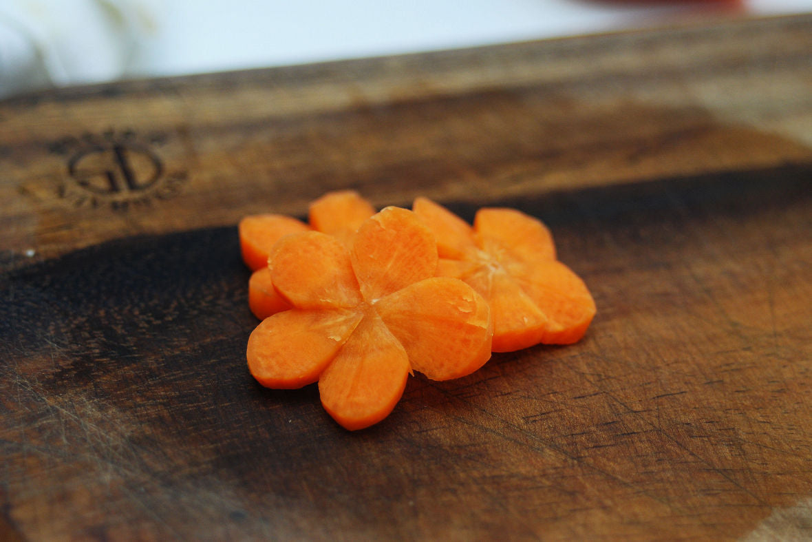 First prepare ingredients. Carrots will look beautiful when cut into decorative shapes.