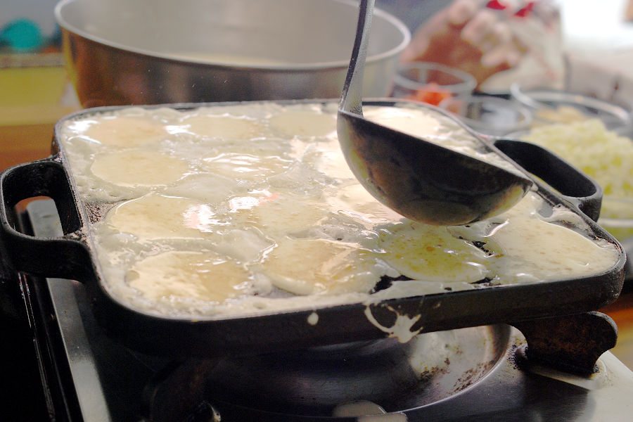  Pour the dough into the takoyaki cooker.