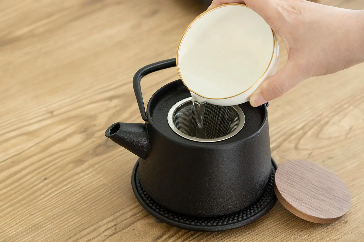 Pouring cooled water into teapot