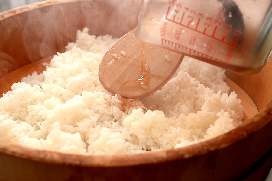 To prepare sushi rice, drizzle sushi vinegar evenly on top of cooked rice (You can make sushi vinegar by mixing 3 tablespoons of rice vinegar, 2 tablespoons of sugar, 1/2 teaspoon of salt (not included in the list of ingredients)). Gently fold the rice repeatedly with a rice spatula without smashing grains. Add toasted white sesame seeds to the sushi rice. 