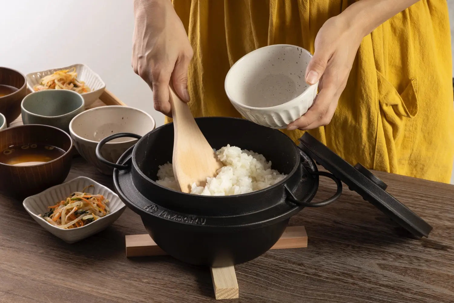 Scooping rice out of the Iwachu cast iron rice cooker