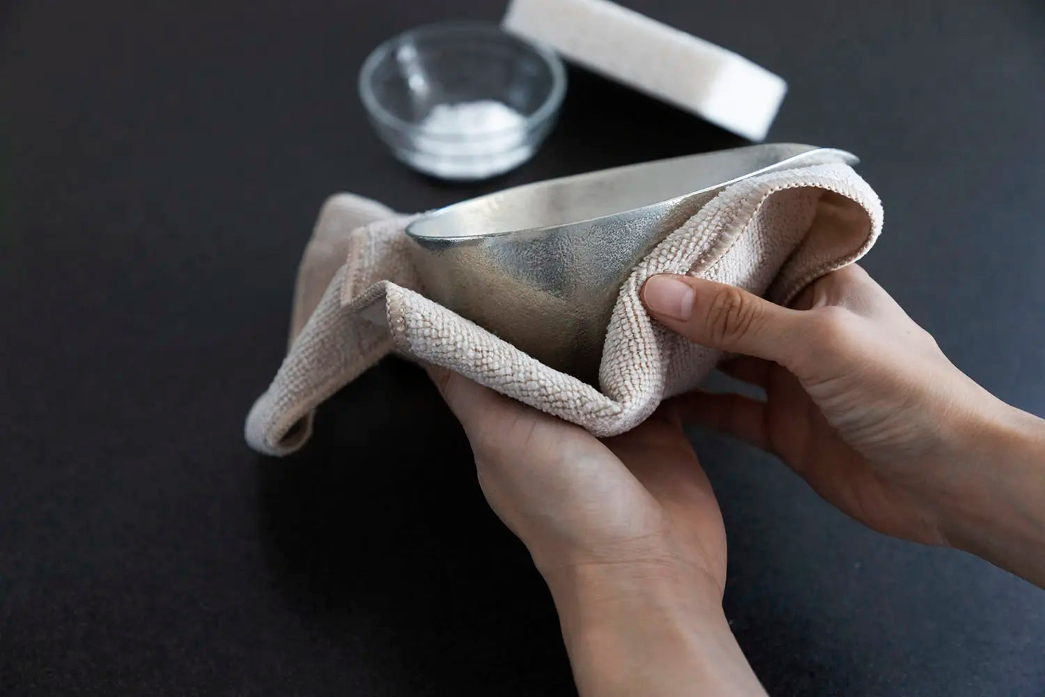 Wiping off tinware with a dry towel