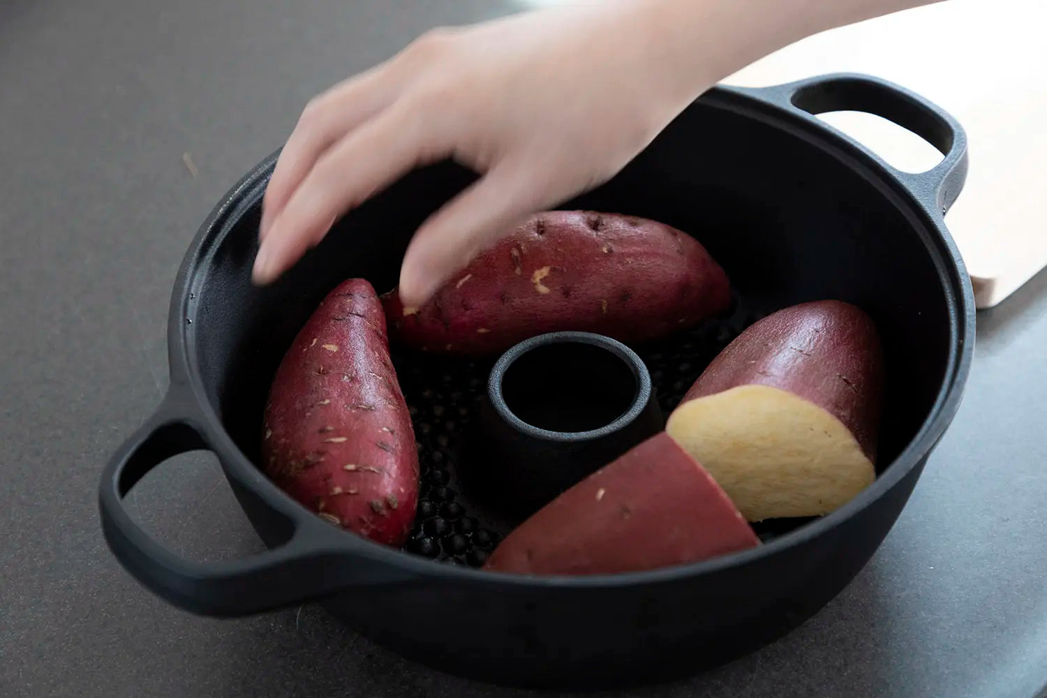 Placing the sweet potatoes in the pot