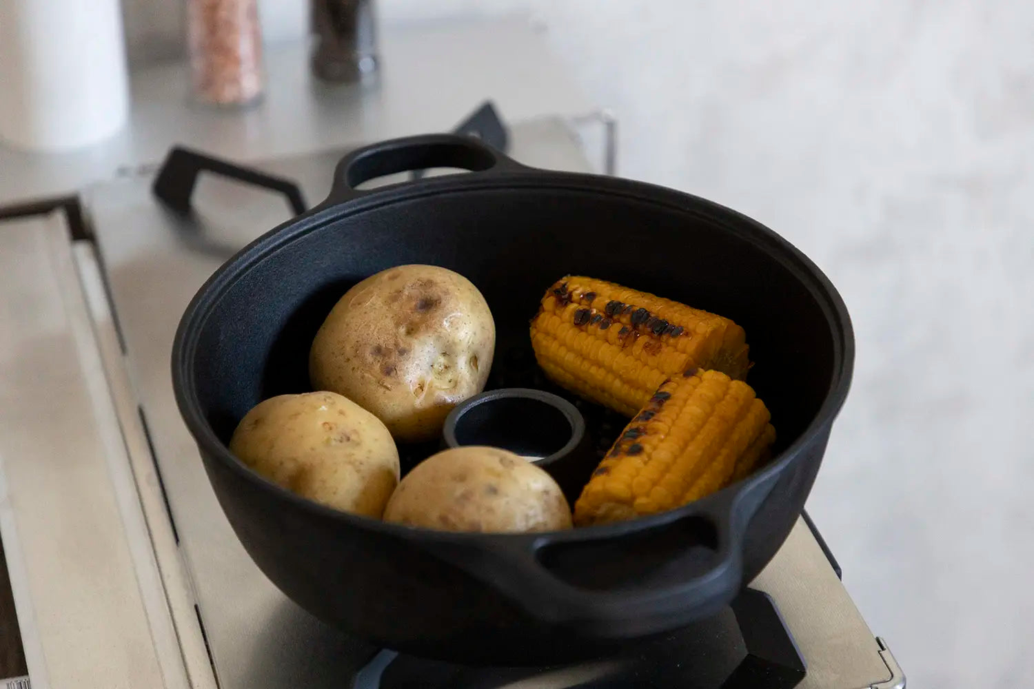 Roasting potatoes and corn in the pot