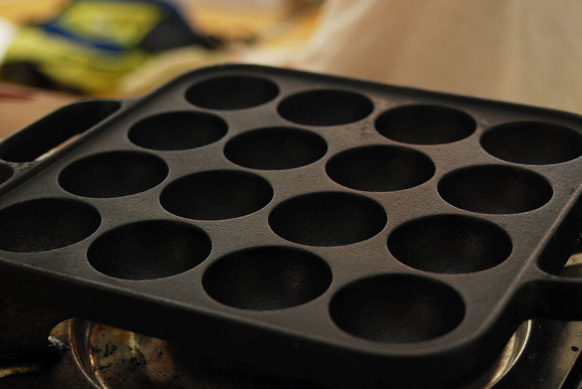 Place the Takoyaki pan on the gas stove and pour olive oil in each hole.