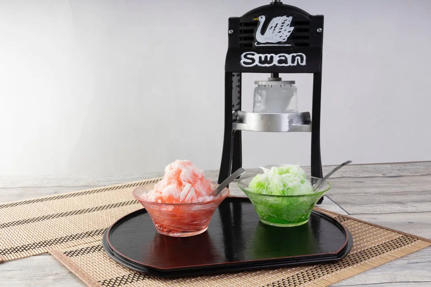 Swan shaved ice machine with two bowls of shaved ice