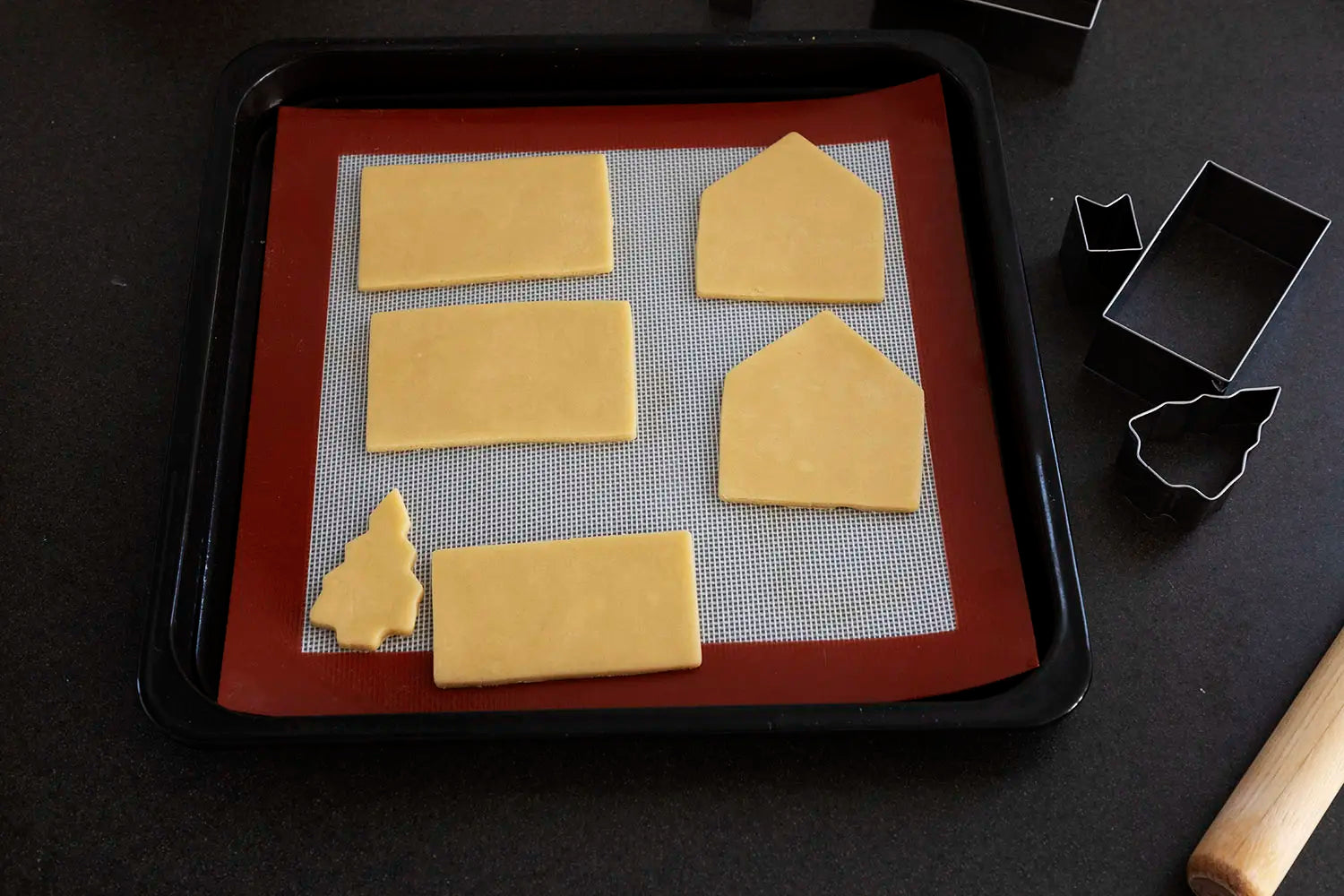 Placing cut cookie dough onto baking sheet