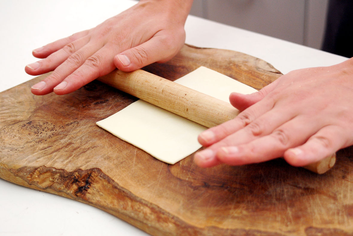 Extend the defrosted pie sheet with a rolling pin.