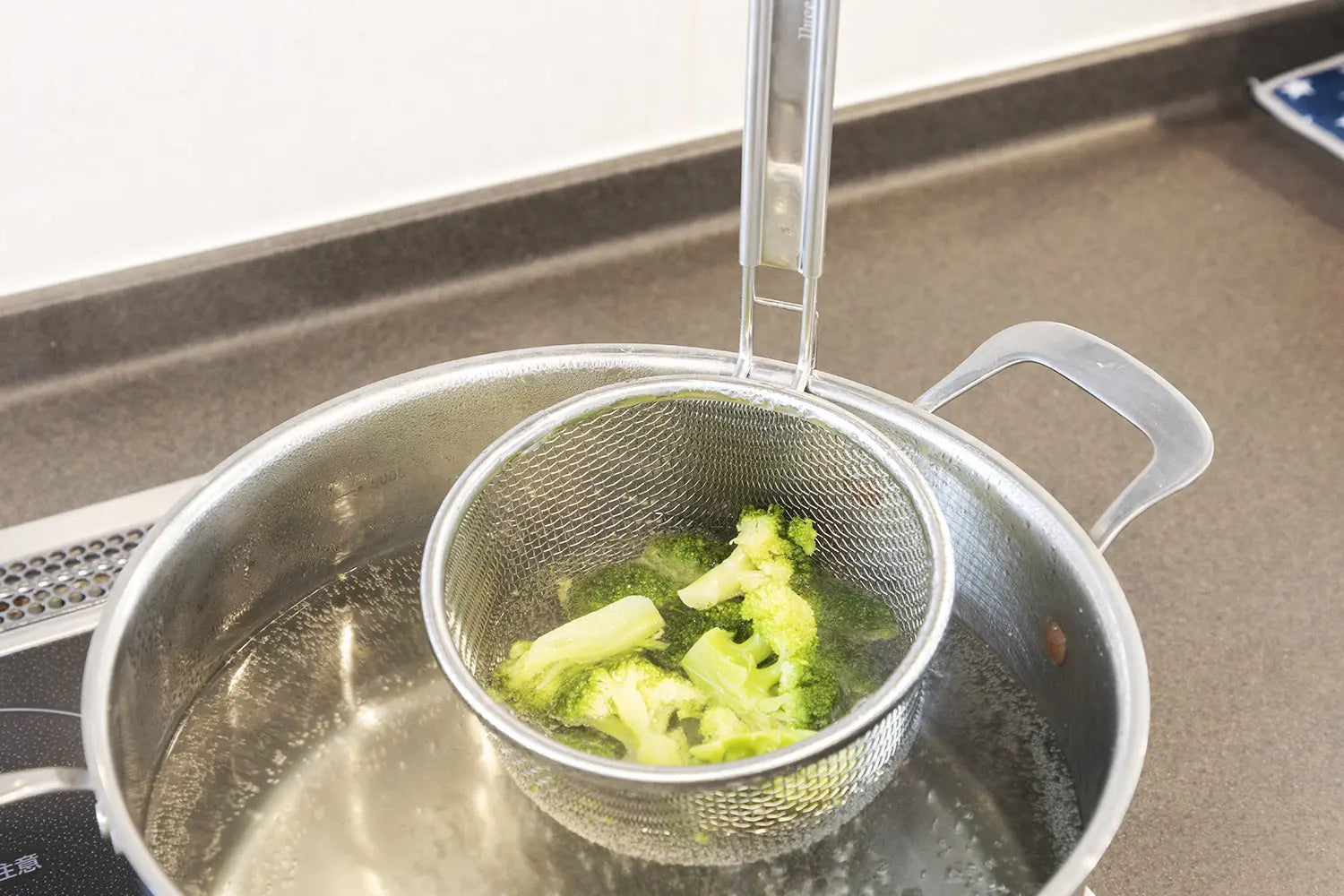 Cooking Broccoli with a Three Snow Strainer