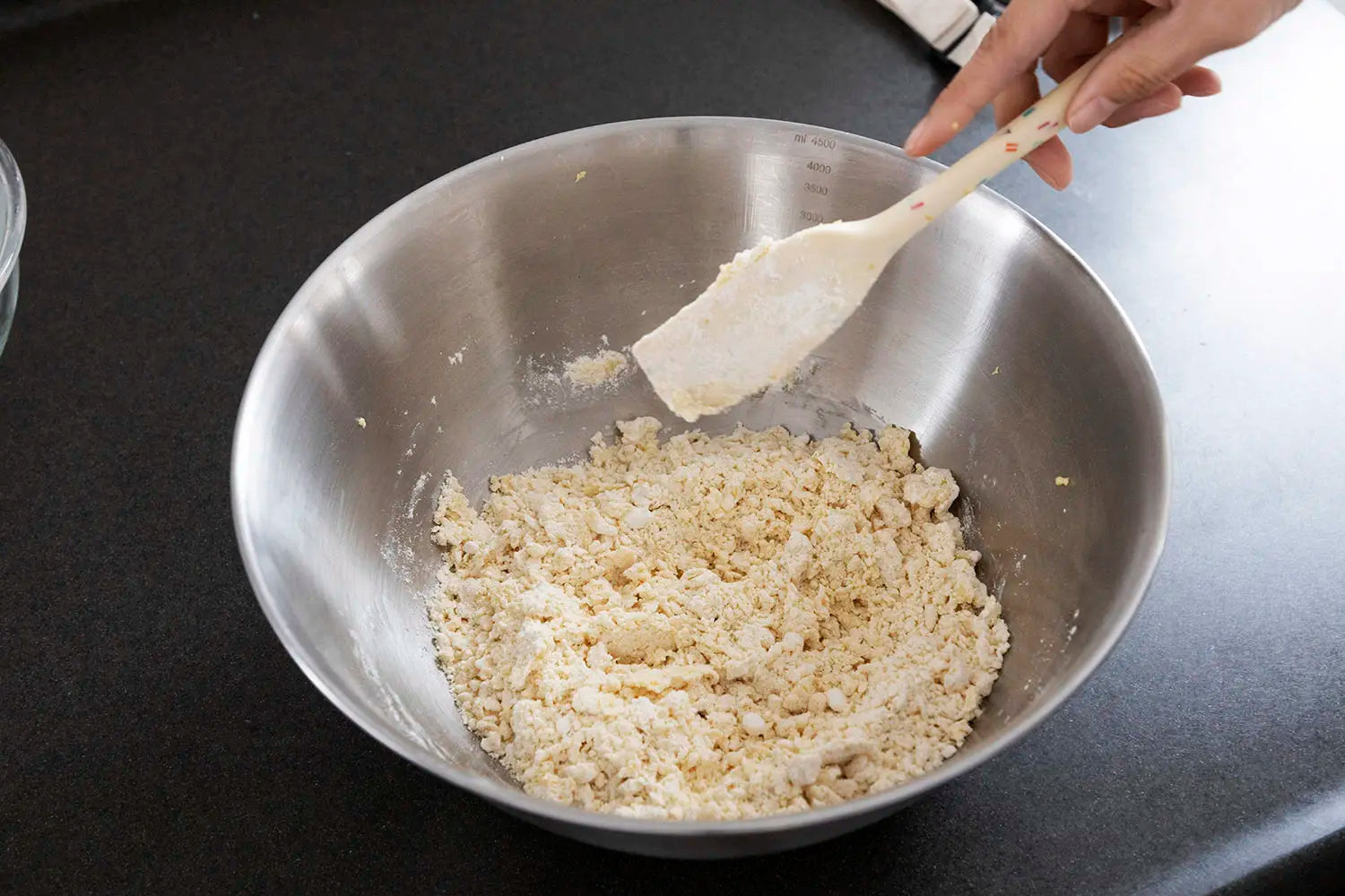 Mixing flour into butter-sugar-egg mixture