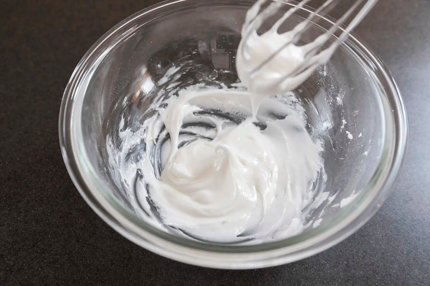Mixing and beating eggs with powdered sugar