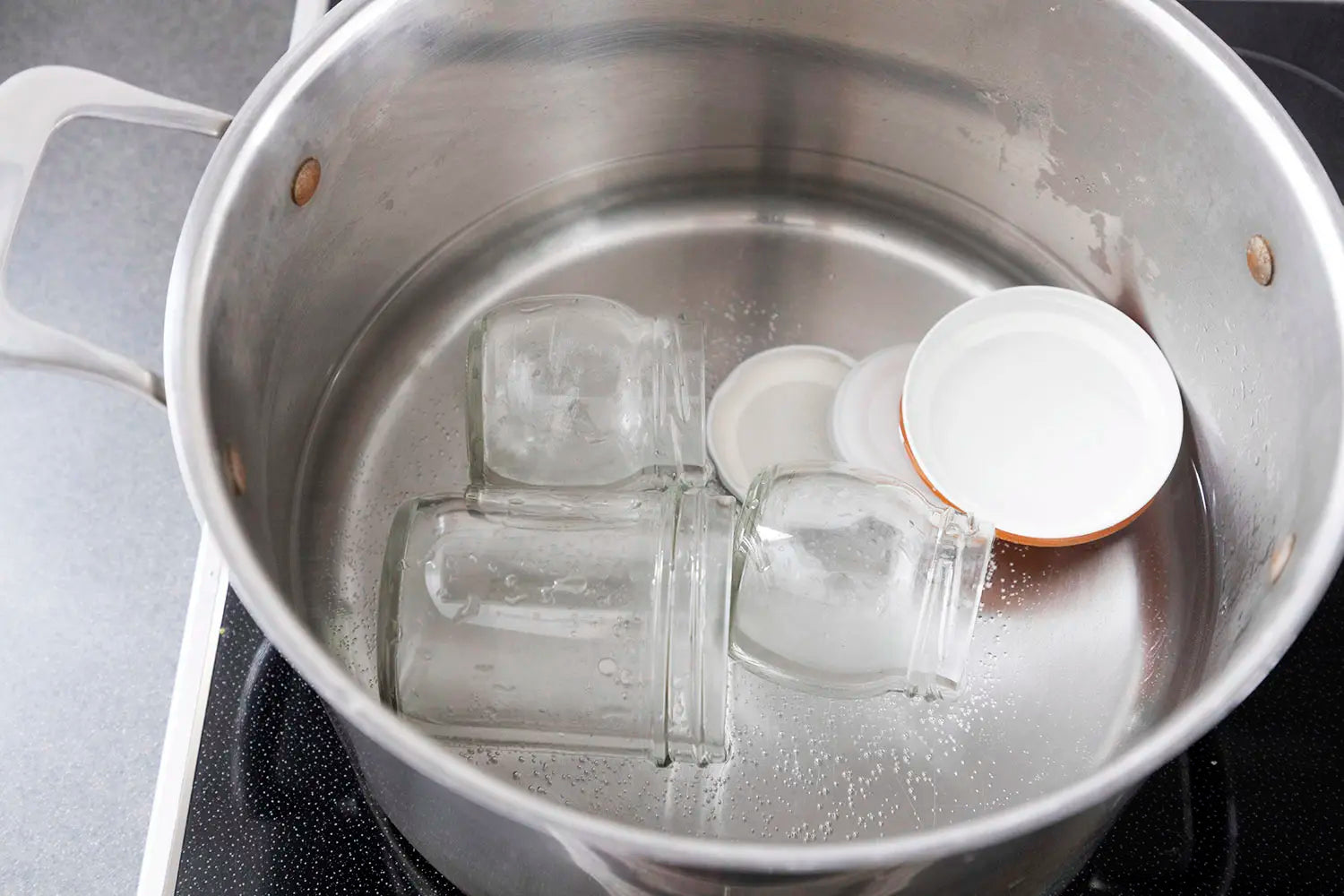 Sterilizing jars in boiling water