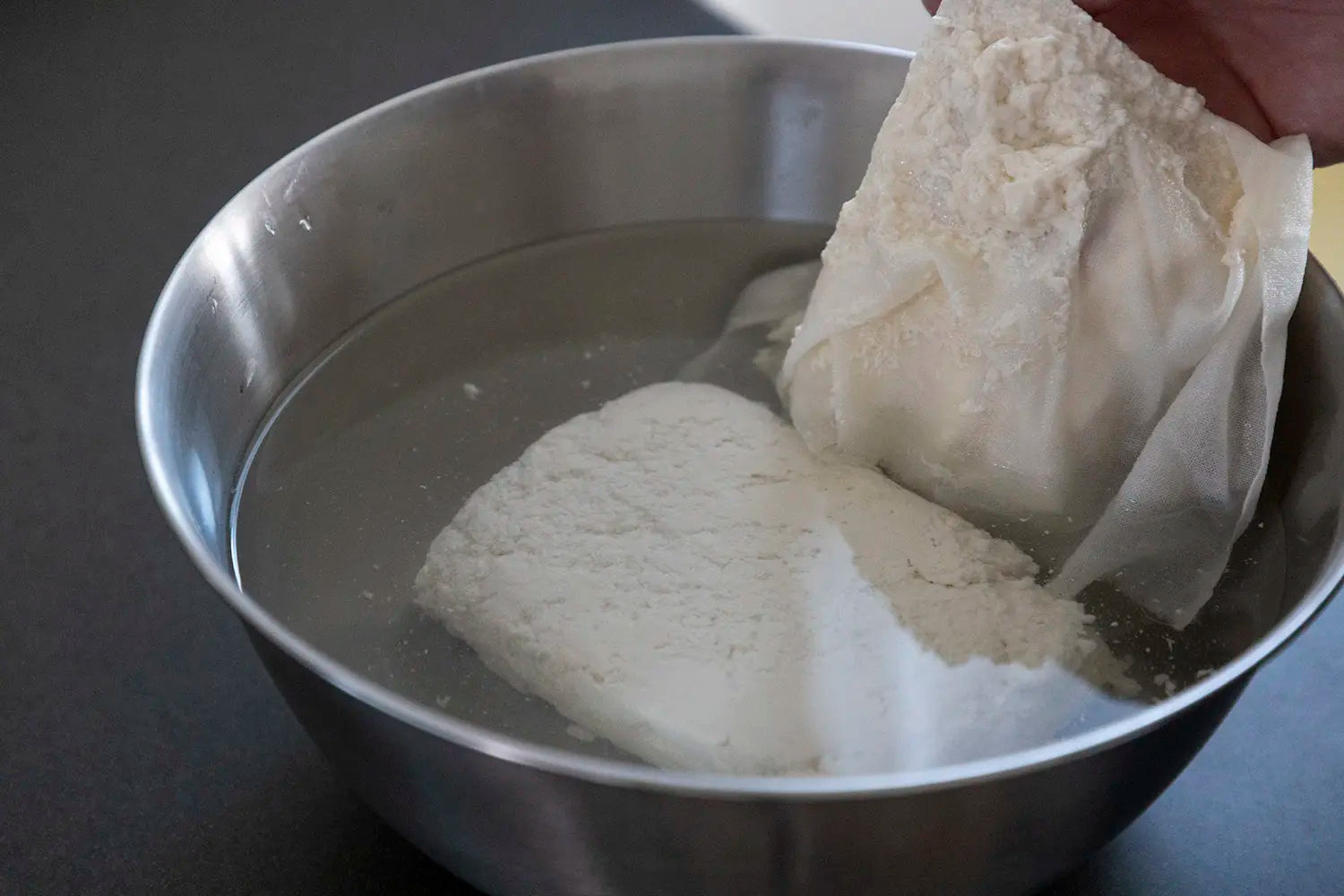 Peeling cheesecloth from tofu