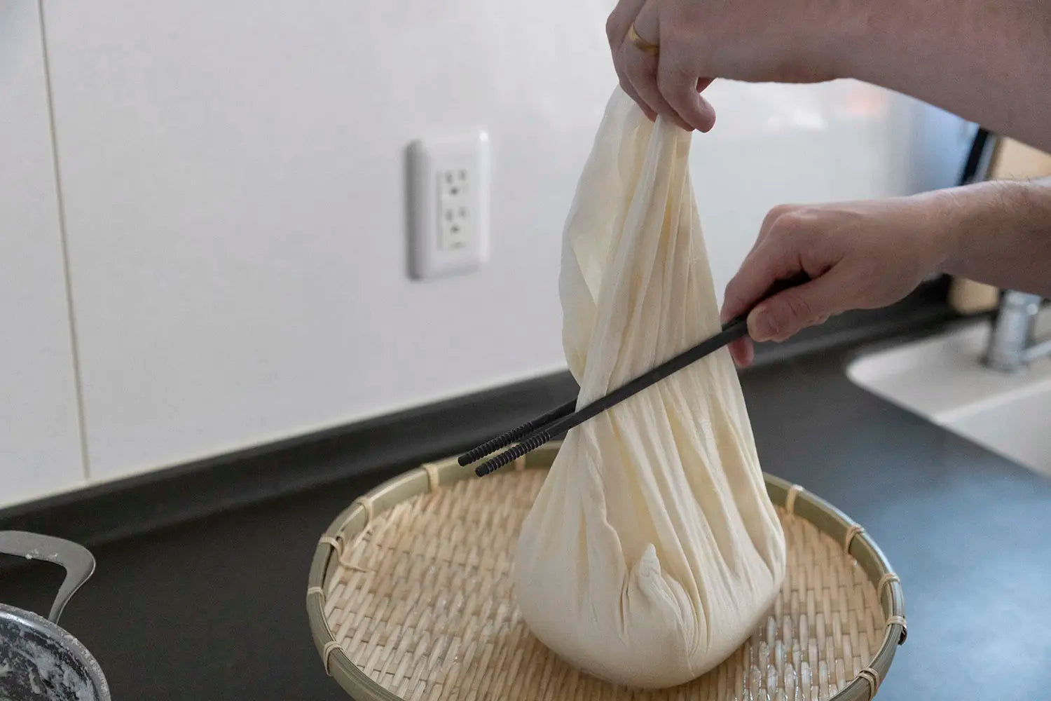 Squeezing ground soybeans with chopsticks