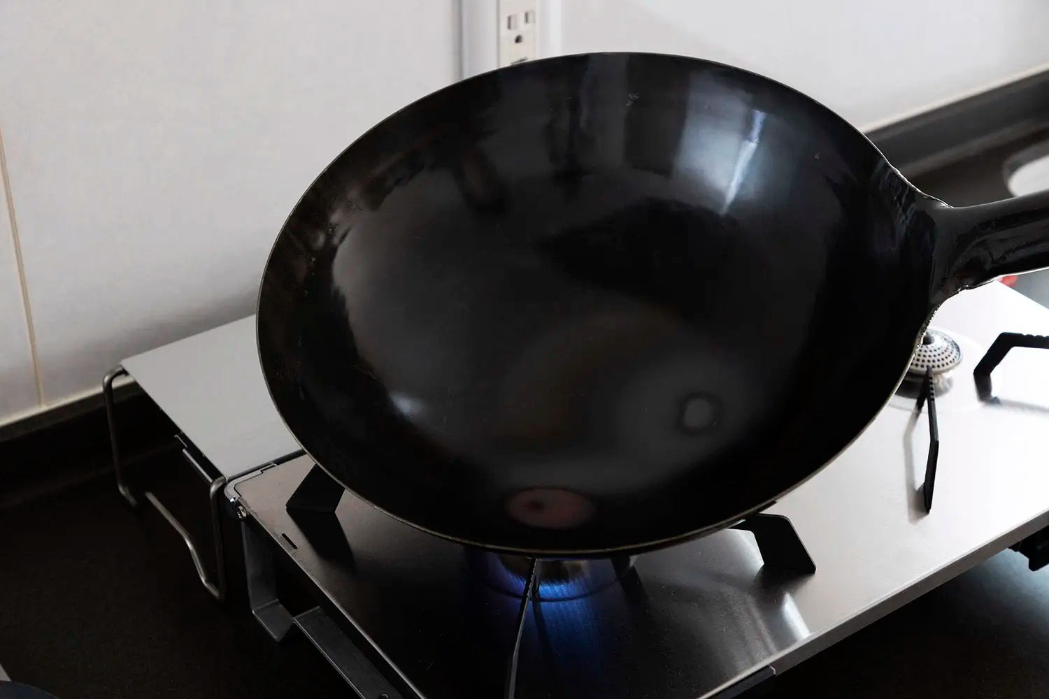 Burning off the anti-rust coating on a new wok