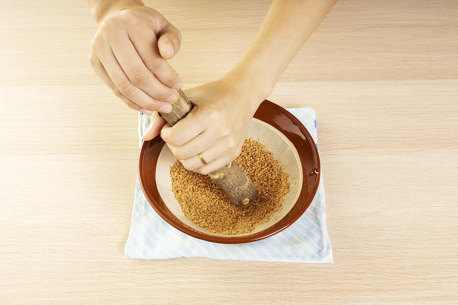 Female hands gripping the pestle