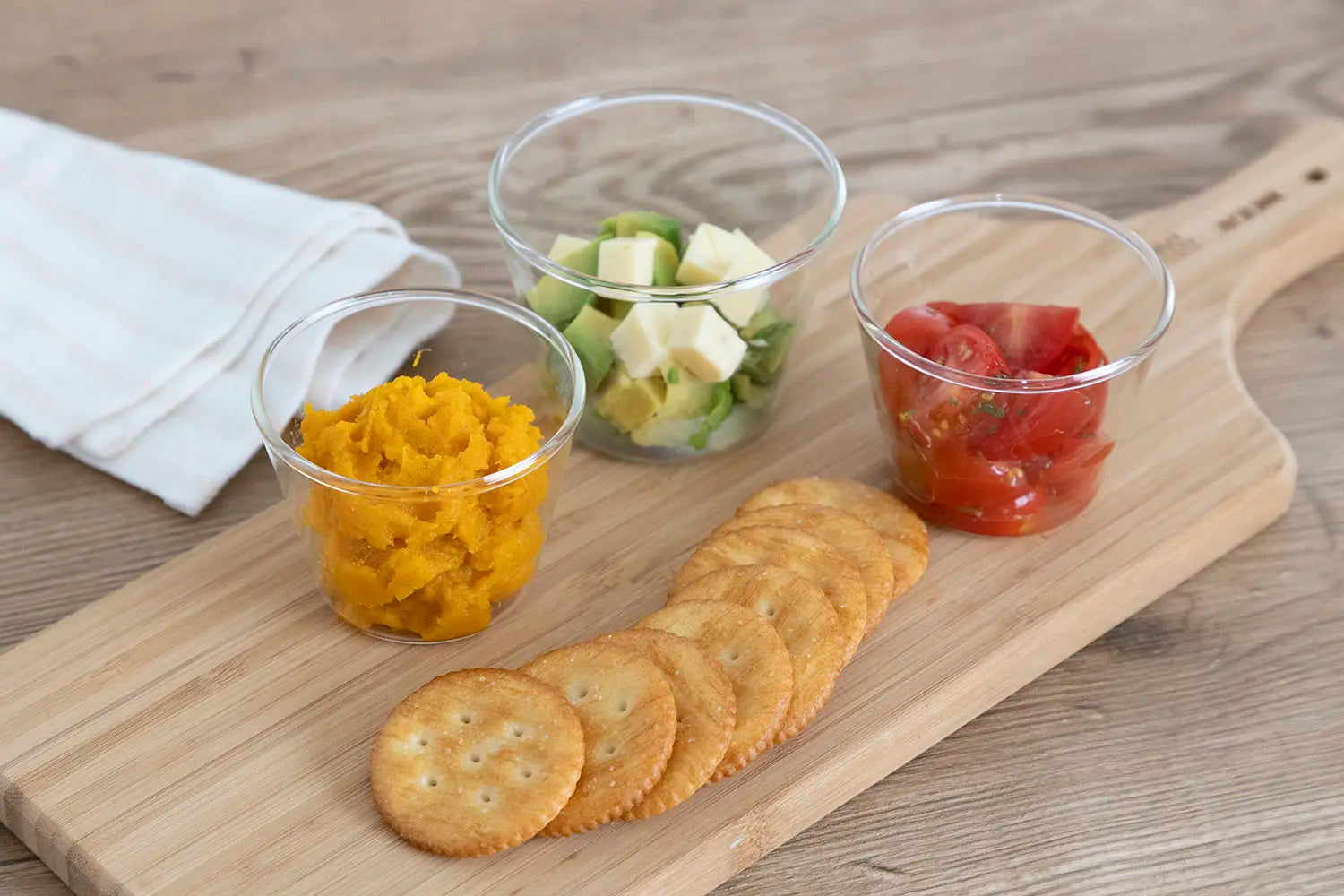 Snack ingredients in pudding cups with crackers