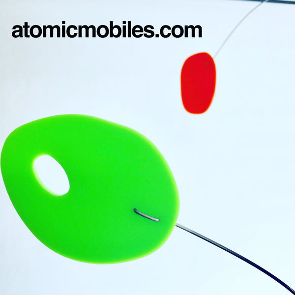 Gros plan du mobile d'art moderne MCM en vert lime et orange par AtomicMobiles.com