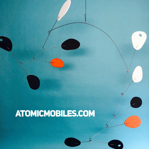 Mobile d'art suspendu mobilisé par AtomicMobiles en noir, orange, blanc et marron