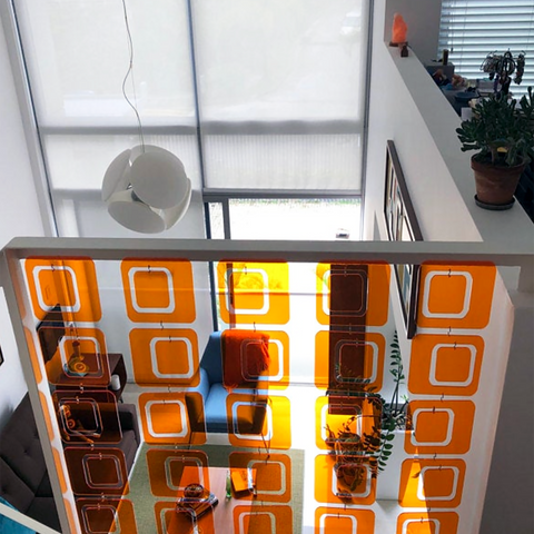 Clear Orange Coolsville Room Divider installed in stairway railing in mid century modern home by AtomicMobiles.com
