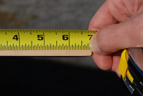 hand close up measuring with a tape measure