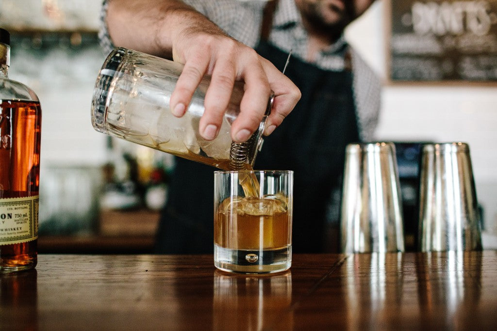 Bartender mixing an old fashioned made with Bulleit bourbon