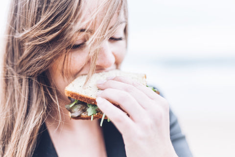 A girl eating a sandwich.