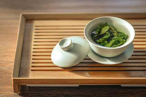 Green tea on a wooden tray.