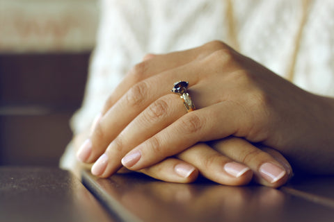 A pair of hands with a wedding ring.