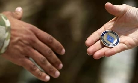 handing off an challenge coin