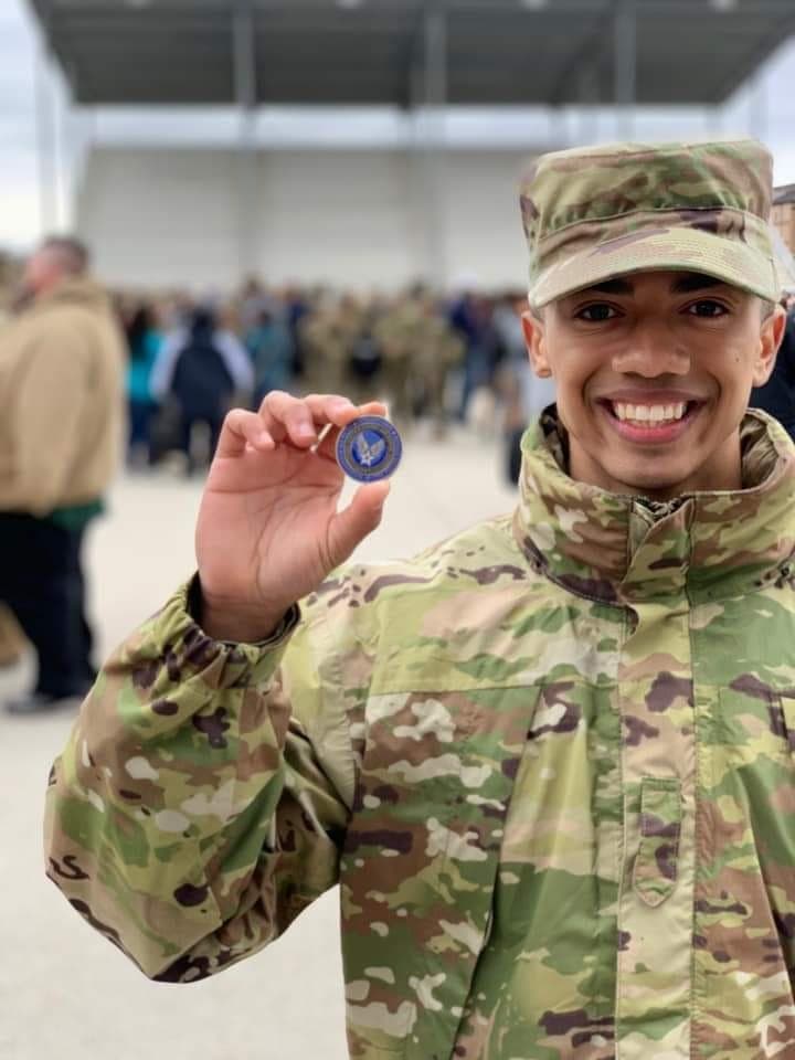Air Force Airman holds his challenge coin