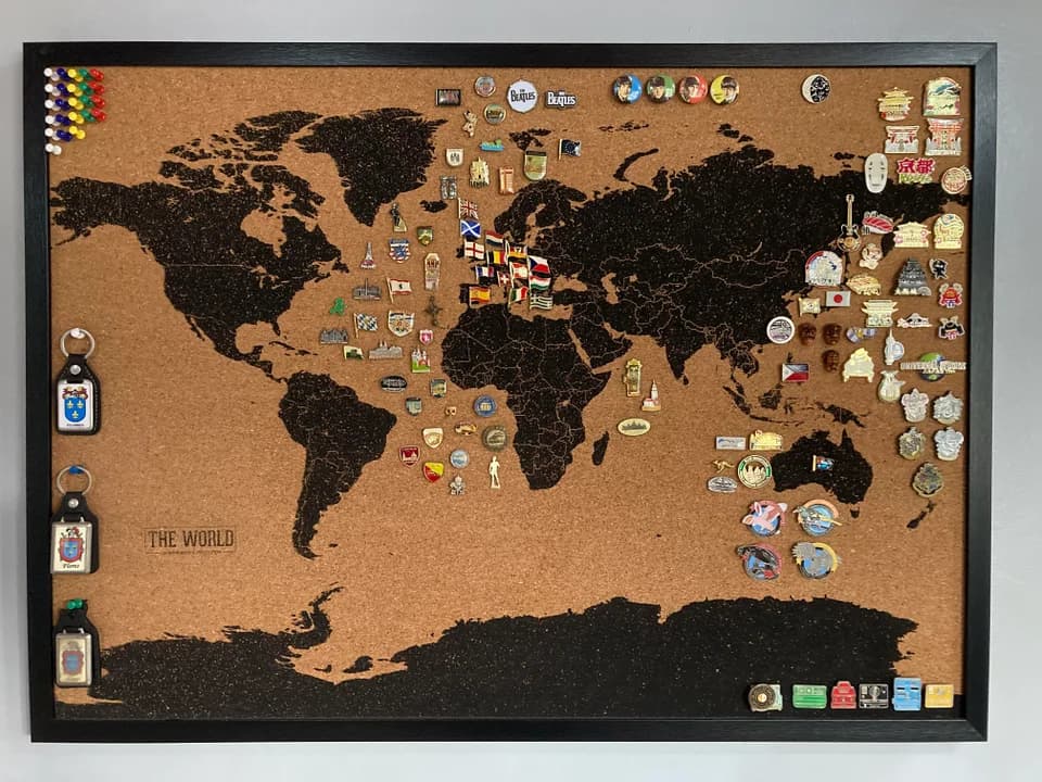 Corkboard enamel pin display with map stencil