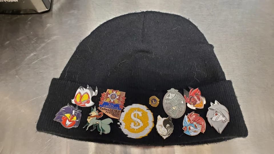 stocking hat with enamel pins attached