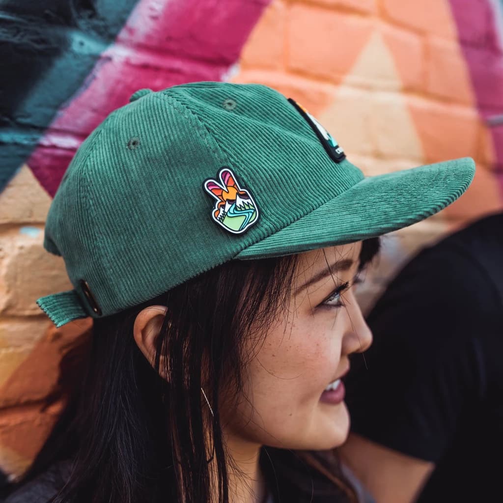 Girl wearing a cap with an enamel pin attached