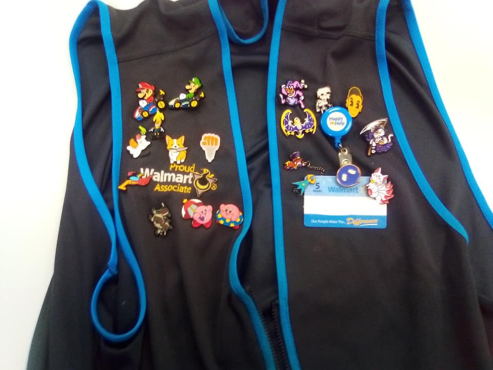 Walmart vest with enamel pins attached