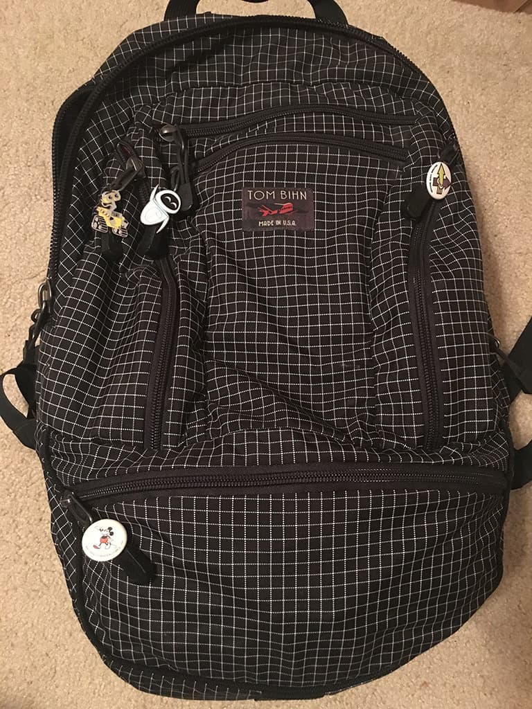 Backpack with enamel pins attached to the zippers