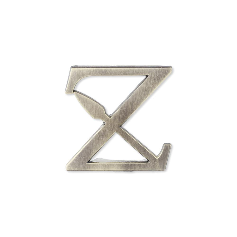 Custom antique distressed vintage lapel pin bespoke lettering with badge style clasp and cutout details in the shape of the letter Z