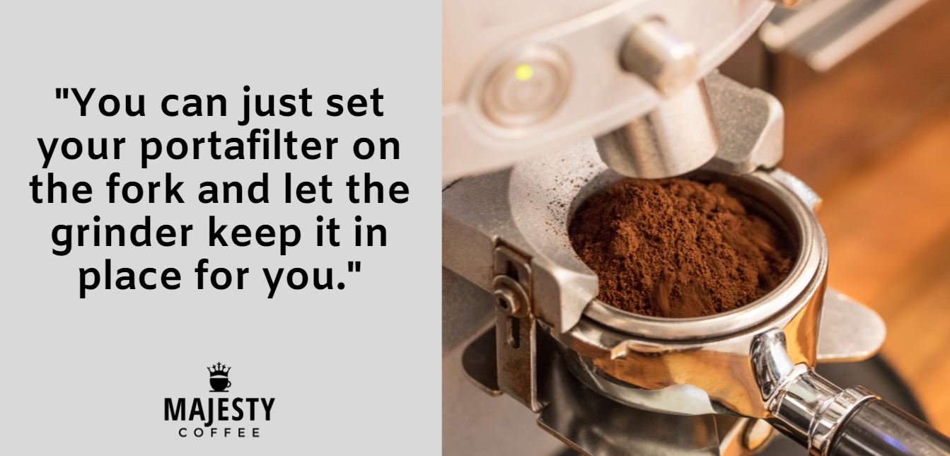 You can just set your portafilter on the fork and let the grinder keep it in place for you.